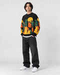 Model wearing the black cat and moon sweater, three-quarter view