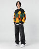Model wearing the black cat and moon sweater, three-quarter view