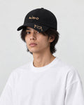 Model wearing the black mizo cat embroidered baseball cap with a white tee, three-quarter view