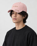 Model wearing the pink mizo cat embroidered baseball cap with a black tee, three-quarter view