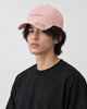 Model wearing the pink mizo cat embroidered baseball cap with a black tee, three-quarter view
