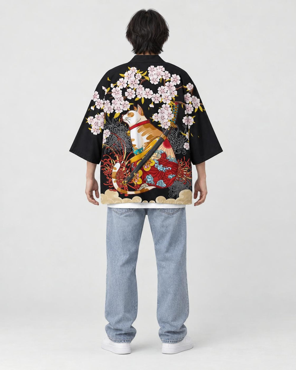 Full-length back view of a man in the black haori with a calico cat and a katana under pink blossoms, white tee and jeans