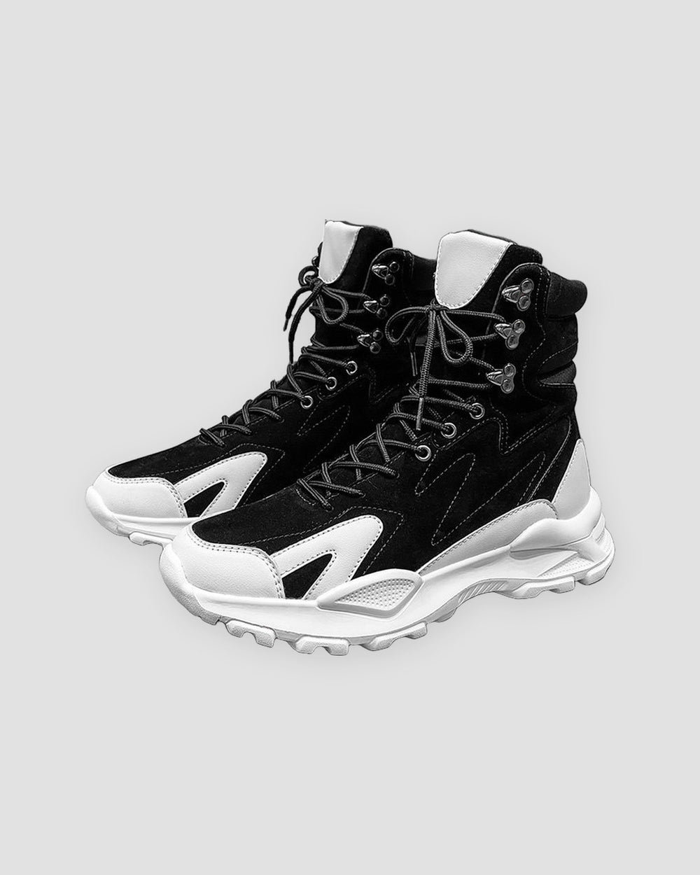 Black high-top sneakers with white wing overlays and a chunky white sole, side view