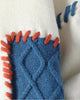 Close-up of the blue cable patch edged with orange whipstitching