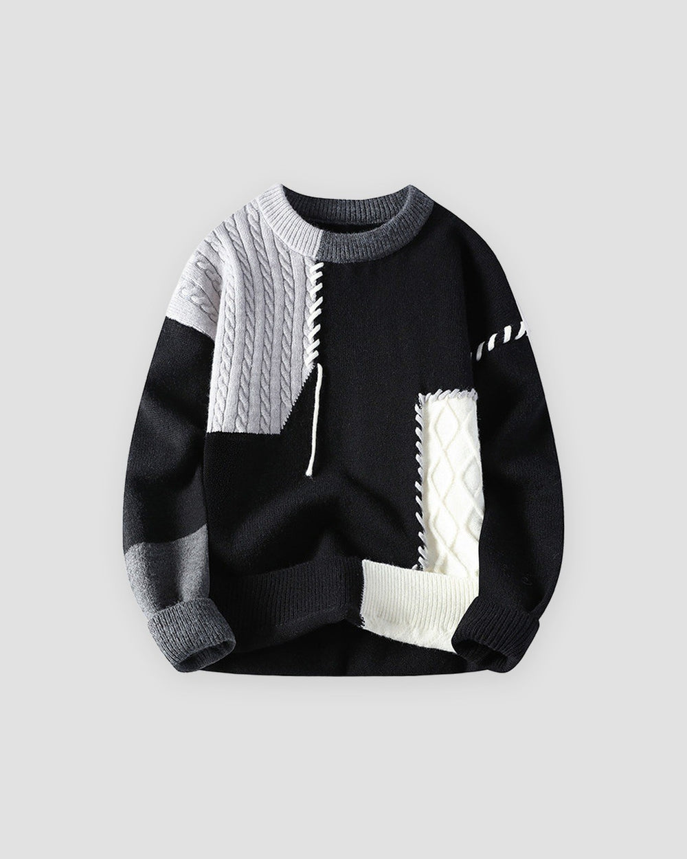 Black sweater with gray and white cable-knit patches, front view