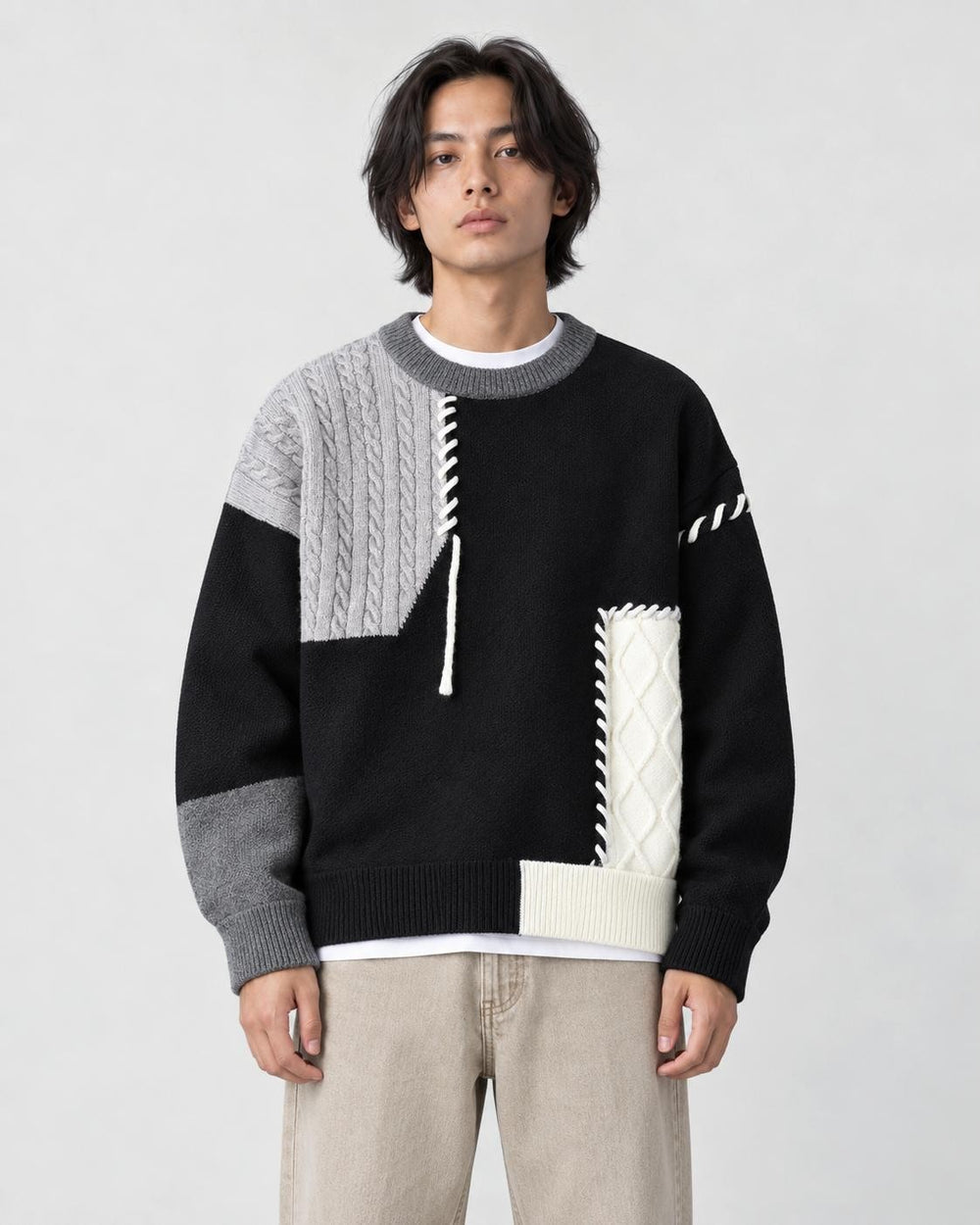 Model wearing the black cable patch sweater, front view