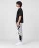 Model wearing the gray color block jogger pants, side view of the curved panels