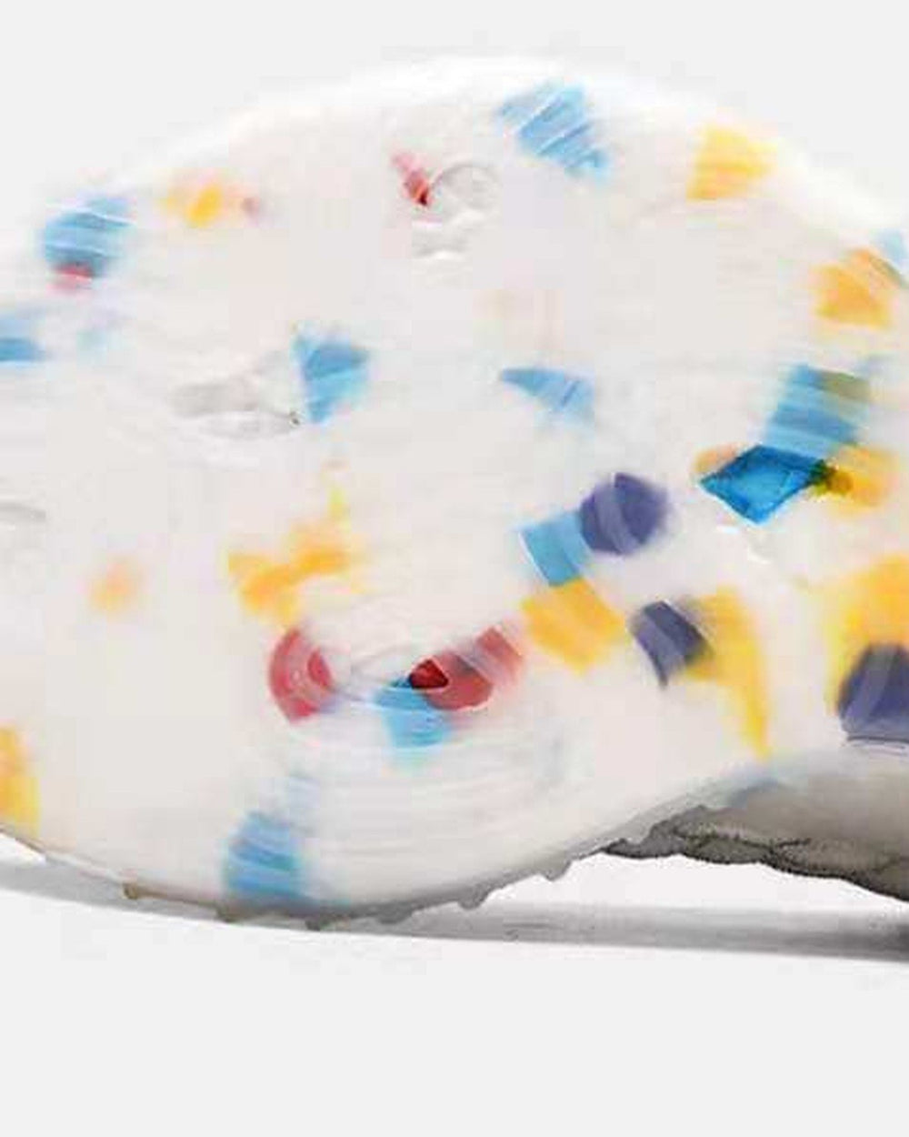 Close-up of the translucent sole with blue, yellow and red granules
