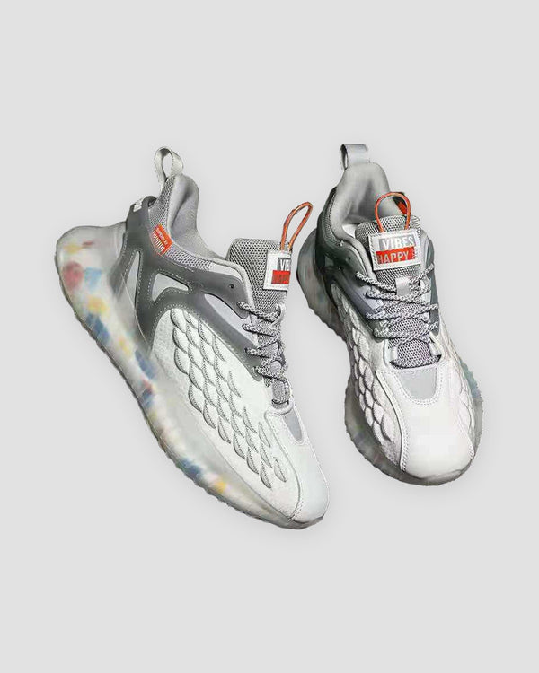 Pair of white and light gray knit running sneakers with confetti-speckled soles