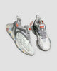 Pair of white and light gray knit running sneakers with confetti-speckled soles