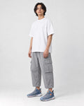Model wearing the ice blue knit running sneakers with light gray cargo pants