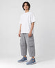 Model wearing the ice blue knit running sneakers with light gray cargo pants