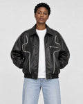 Model wearing the black PU leather zip jacket with white contour piping, front view