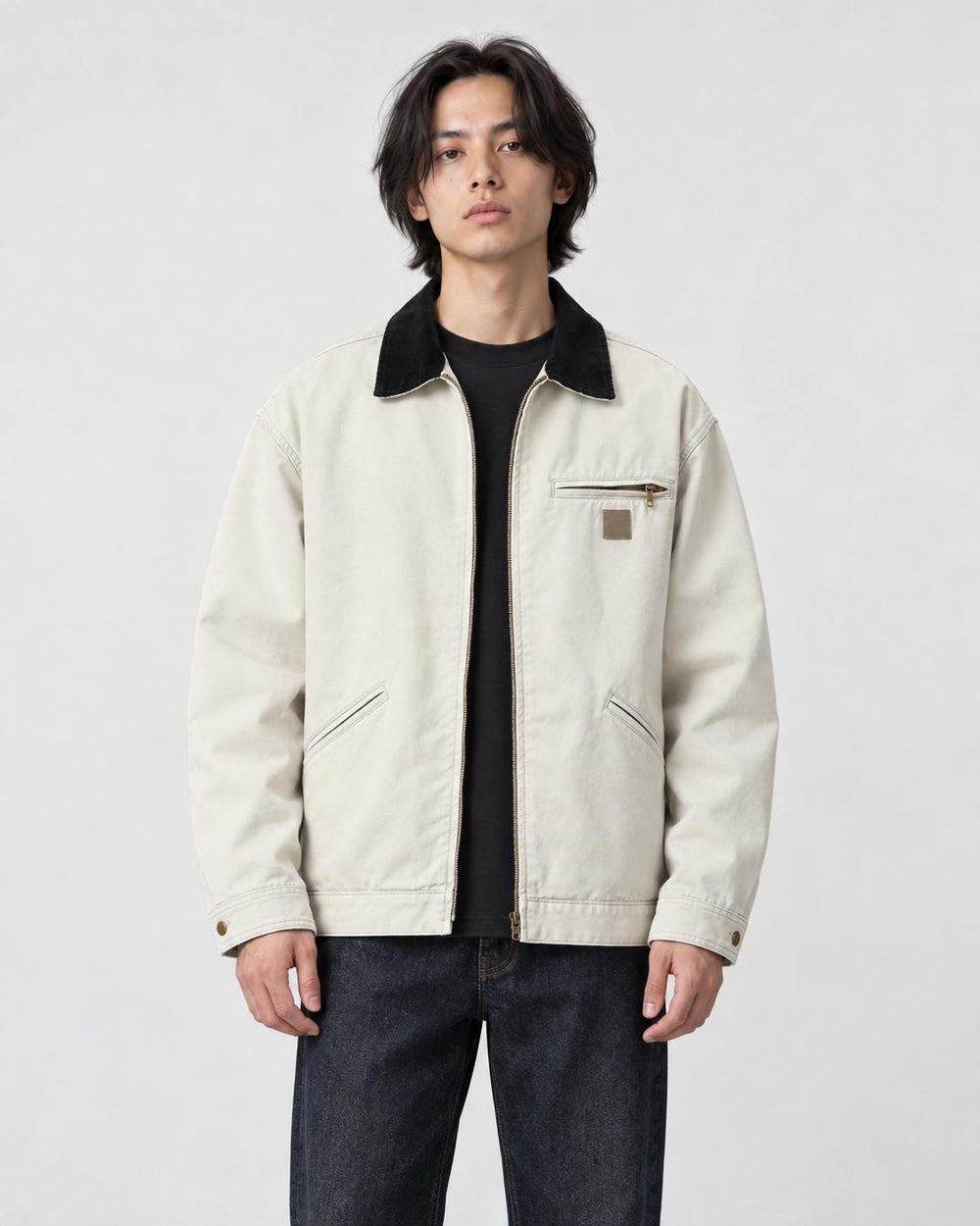 Model wearing the stone cotton chore jacket with a black corduroy collar, front view