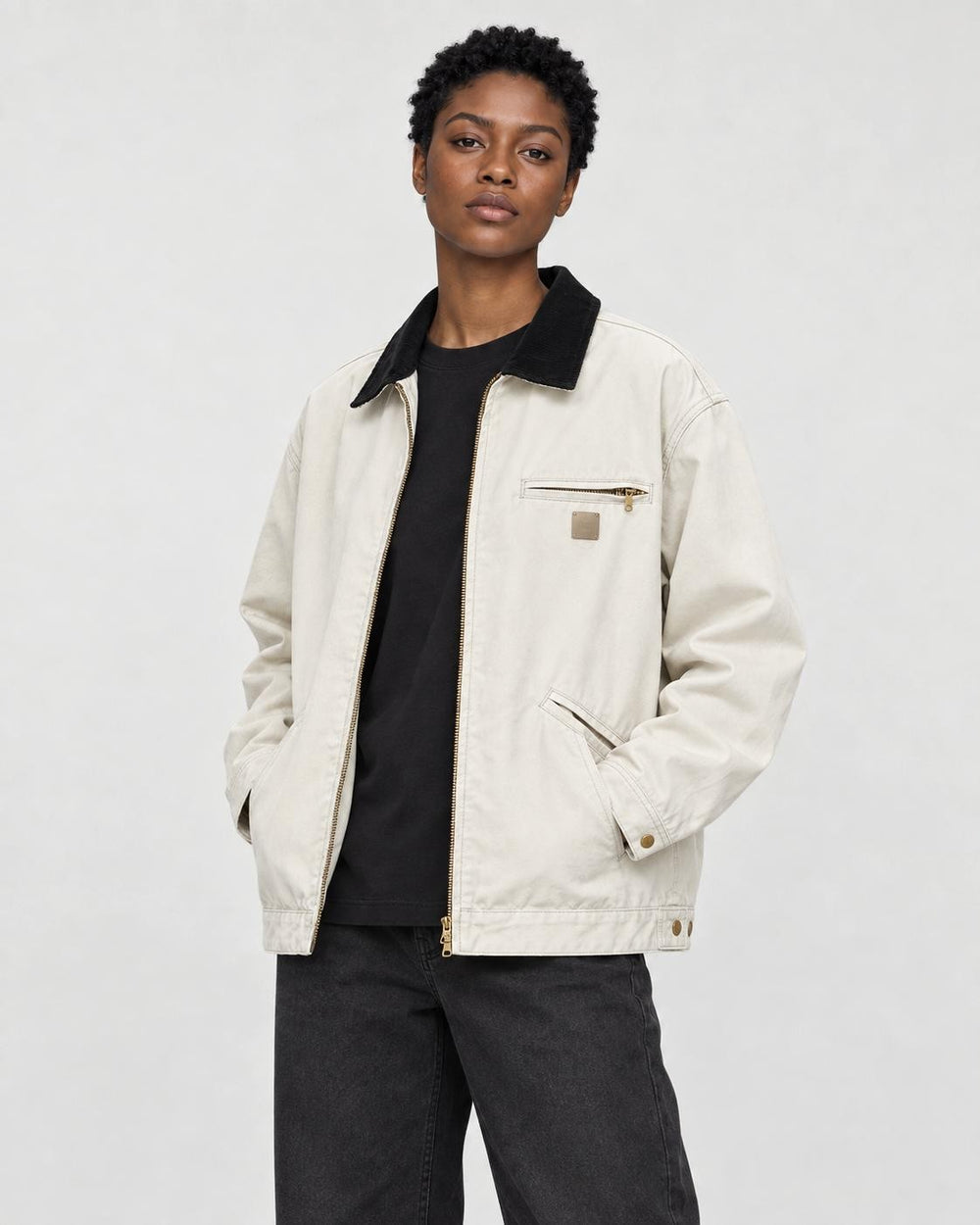 Model wearing the chore jacket open over a black tee, three-quarter view