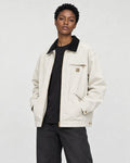 Model wearing the chore jacket open over a black tee, three-quarter view