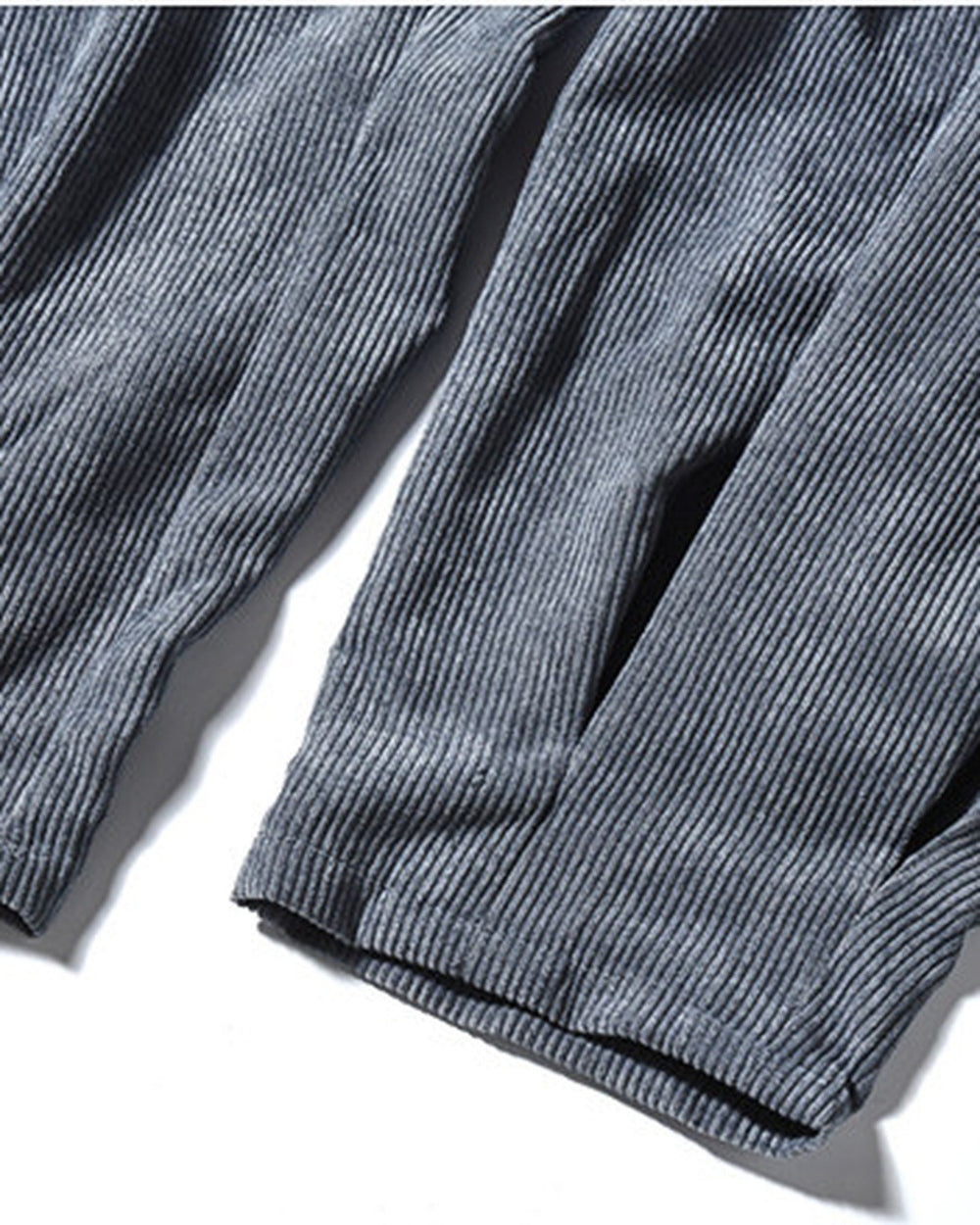 Close-up of the gathered pleated cuff on the blue gray corduroy pants
