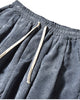 Close-up of the elastic waist, cream drawcord and pocket on the blue gray corduroy pants