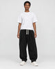 Model wearing the black corduroy lantern pants with a white tee, front view
