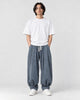 Model wearing the blue gray corduroy lantern pants with a white tee, front view