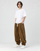 Model wearing the brown corduroy lantern pants with a white tee, three-quarter view