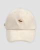 Cream cotton baseball cap with a small embroidered corgi on the front and a curved brim