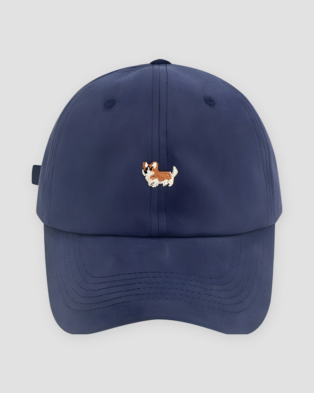 Navy cotton baseball cap with a small embroidered corgi on the front