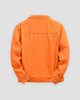 Orange denim trucker jacket, back view, yoke and seam lines in tonal stitching