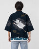 Man seen from behind in the dark navy haori with two white cranes in flight and a teal wave band, over a white tee