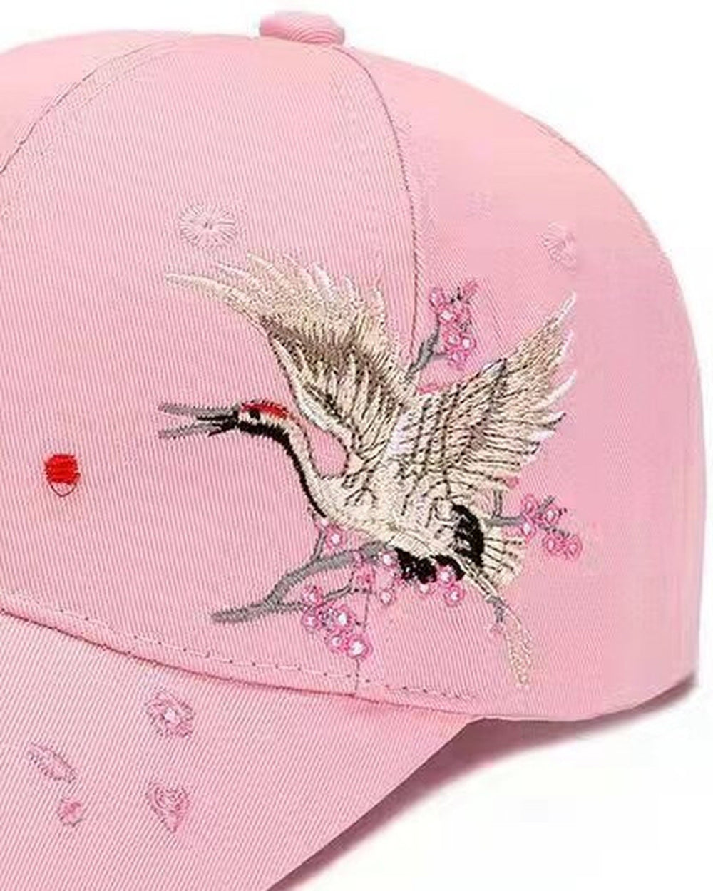 Close-up of the crane and plum blossoms embroidered on the side of the pink cap