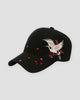 Black baseball cap with a cream and gold crane embroidered over red plum blossoms on the side of the crown