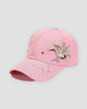Pink baseball cap with a crane in flight embroidered over plum blossoms on the side of the crown