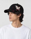 Model wearing the black crane embroidered baseball cap with a white tee, side view