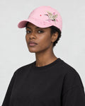Model wearing the pink crane embroidered baseball cap with a black tee, three-quarter view