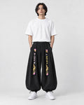 Model wearing the black crane embroidered corduroy pants, front view