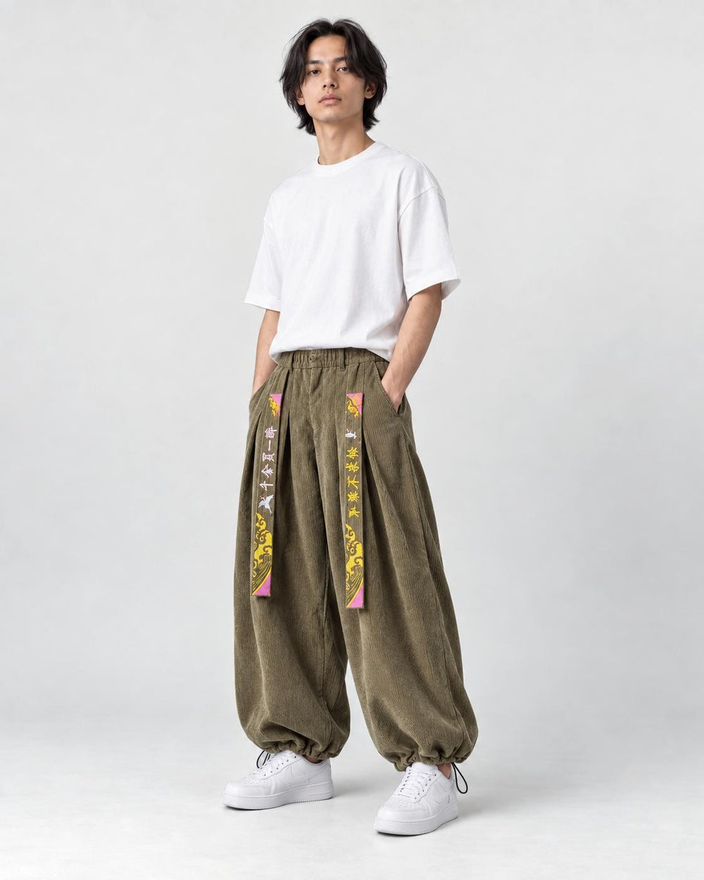 Model wearing the army green corduroy pants, three-quarter view