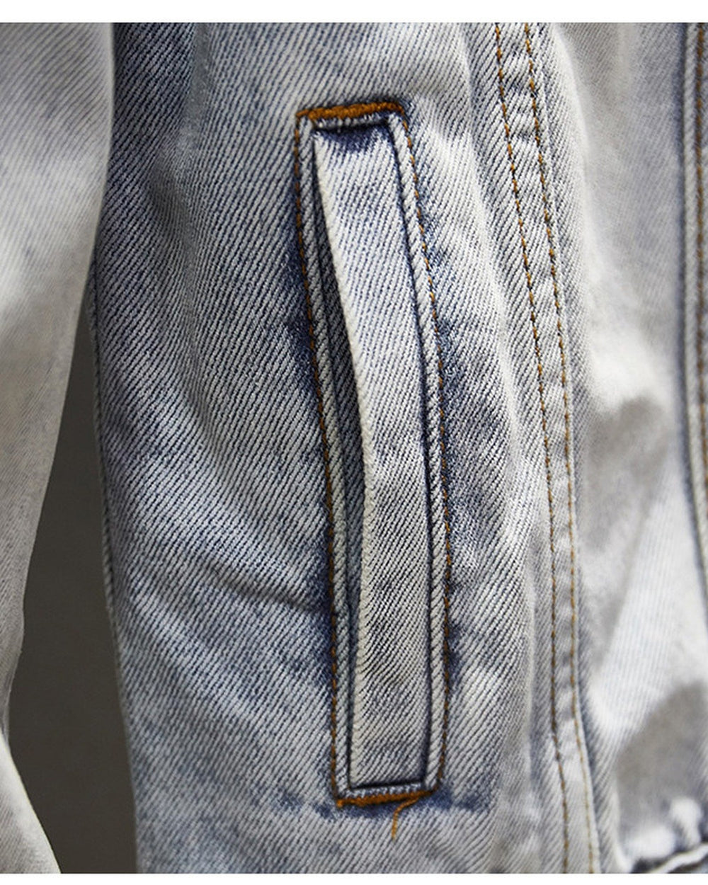 Close-up of a hand pocket on the light-wash denim