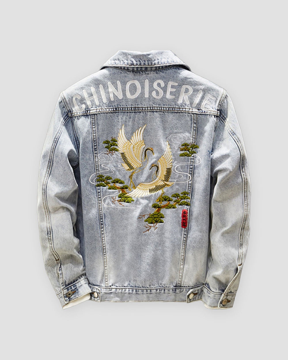 Light-wash denim jacket, back view, CHINOISERIE lettering above an embroidered crane
