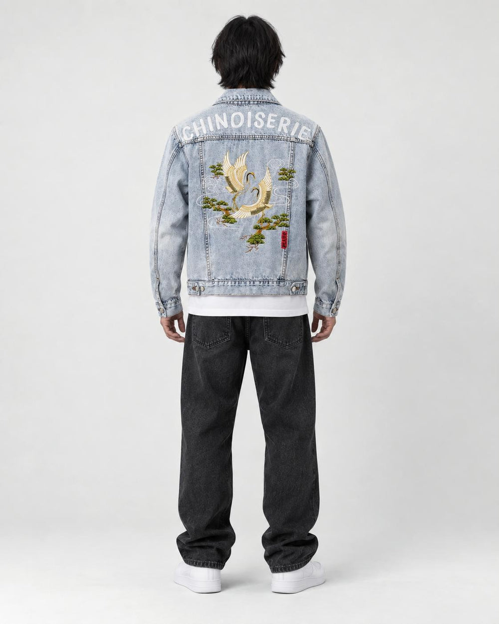 Model wearing the crane embroidered denim jacket, back view