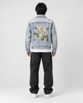 Model wearing the crane embroidered denim jacket, back view