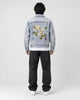 Model wearing the crane embroidered denim jacket, back view