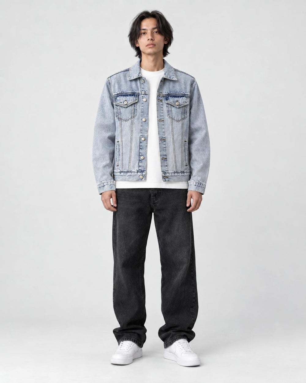 Model wearing the crane embroidered denim jacket over a white tee, front view