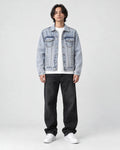 Model wearing the crane embroidered denim jacket over a white tee, front view