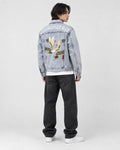 Model wearing the crane embroidered denim jacket, back three-quarter view