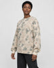 Model wearing the apricot crane print knit sweater with black jeans, three-quarter view