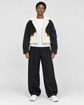Model wearing the black cropped fleece panel jacket, front view