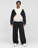 Model wearing the black cropped fleece panel jacket, front view