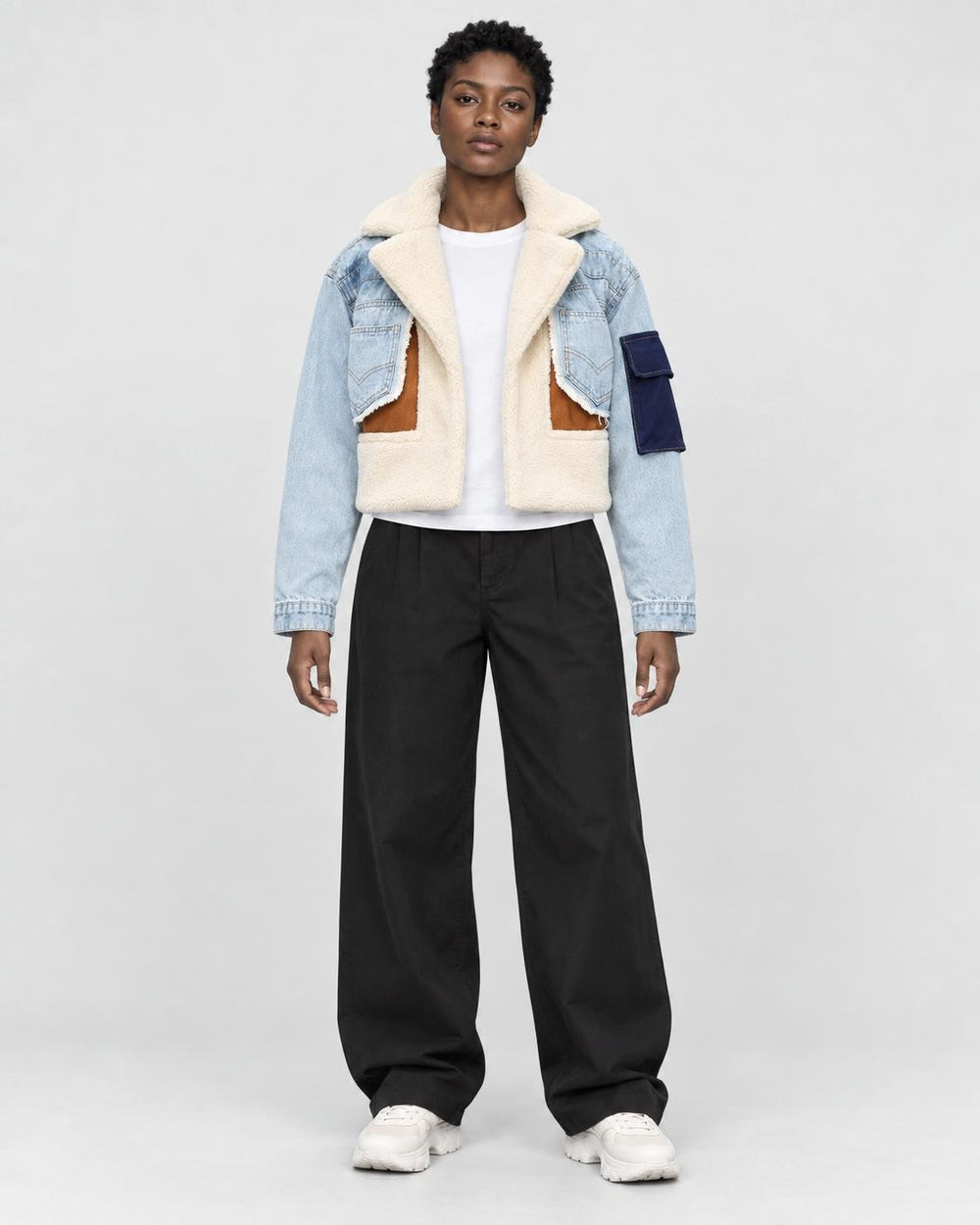 Model wearing the light blue cropped fleece panel jacket, front view