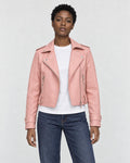 Model wearing the pink cropped moto jacket open over a white tee, front view