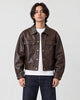 Model wearing the deep brown cropped PU leather jacket with a white tee, front view